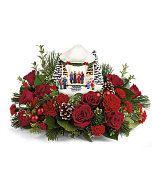 Features red roses, carnations, miniature red carnations, white pine, magnolia leaves, oregonia, seeded eucalyptus and lemon leaf.